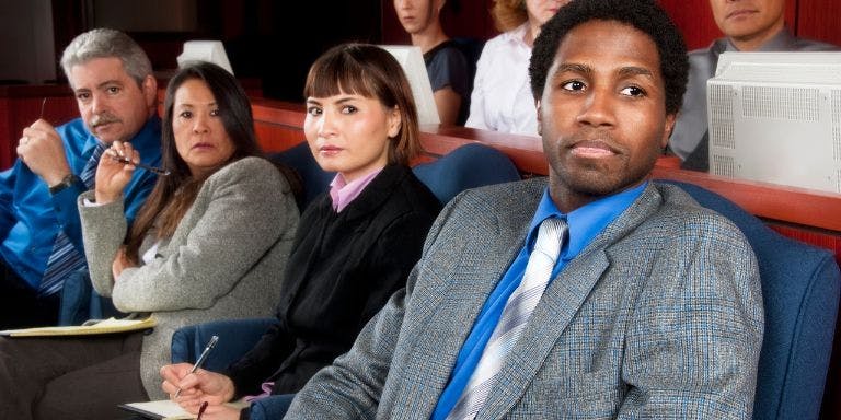 People sitting in a court room part of a jury duty