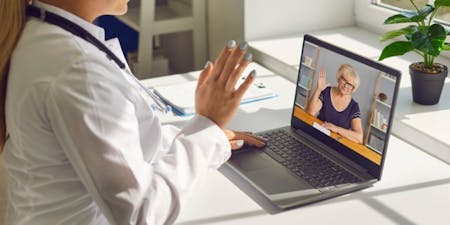 An employer holding a welfare meeting with employee on long term sick leave on a laptop video call.