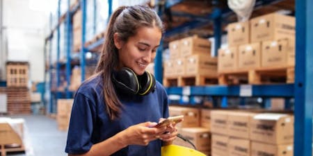 Employee clocking in mobile app Employee using mobile device at work to track working hours and clock in with an app