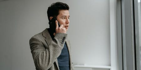 An employer is on the phone discussing a leave of absence with an employee.