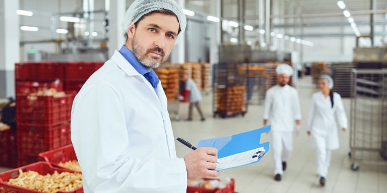 The Food Standards Agency Food inspector in a food warehouse inspecting