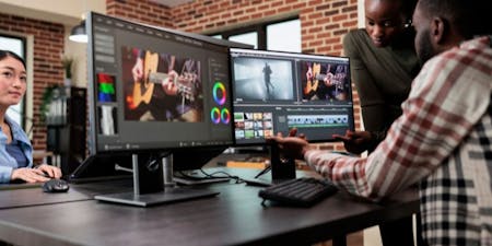 A digital marketing agency team working at a large desk to complete design work Creating industry time tracking and timesheets