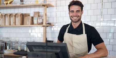 Waiter working behind the bar in a cafe Timesheets and time management for the hospitality sector