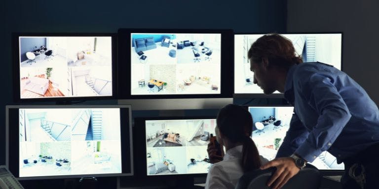 Workplace surveillance Managers monitoring a workplace using surveillance footage