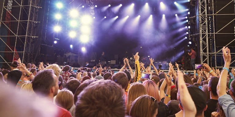 Headline image for article on festival season absence, featuring people at a music festival