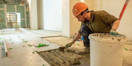 Small construction site safety A man working on a small home renovation wearing PPE