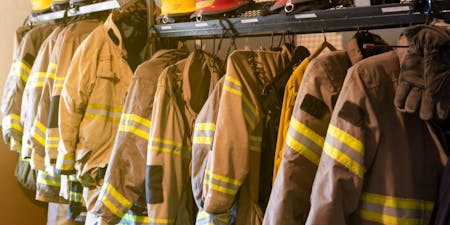 Fire fighter uniform hanging on display in local fire station 