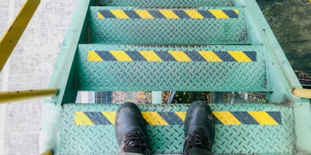 Trips and falls down stairs at work Safety paint used to indicate a stairway to prevent trips and falls downstairs