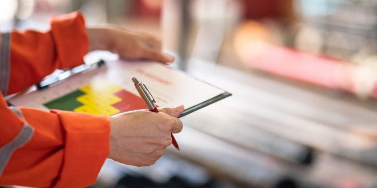 A business owner completing a fire risk assessment