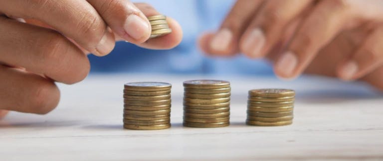 Equal pay day blog image of stacks of coins