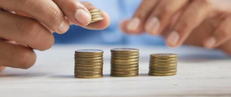 Equal pay day blog image of stacks of coins