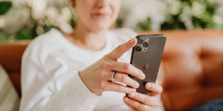 A woman using her mobile phone at home