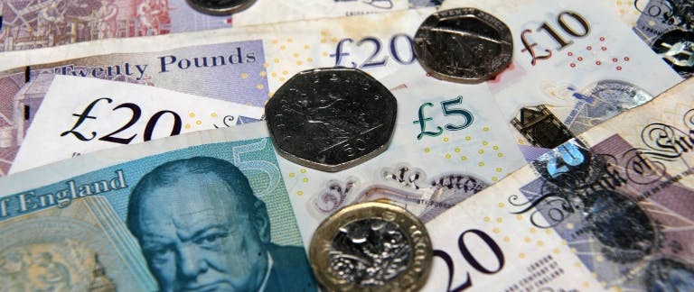 A photograph of British notes and coins on a table