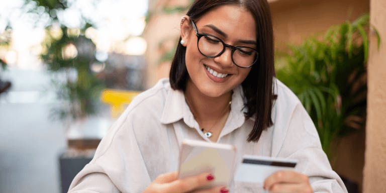 A young woman with glasses smiling looking at Holiday pay A young woman with glasses smiling looking at Holiday pay
