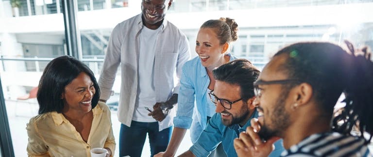 A photo of five people laughing