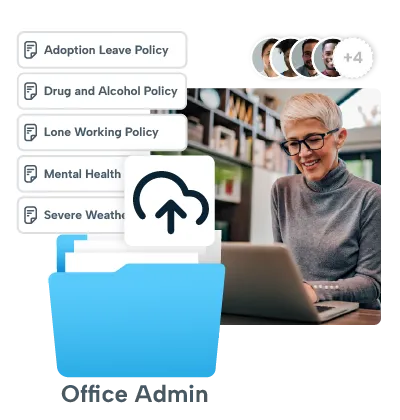 A man is sitting at a desk, working on a laptop. He is wearing glasses and a gray sweater. The laptop screen displays a blue arrow pointing upwards. There are three buttons on the laptop: "Back," "Home," and "Login." The man is smiling and appears to be engaged in his work.