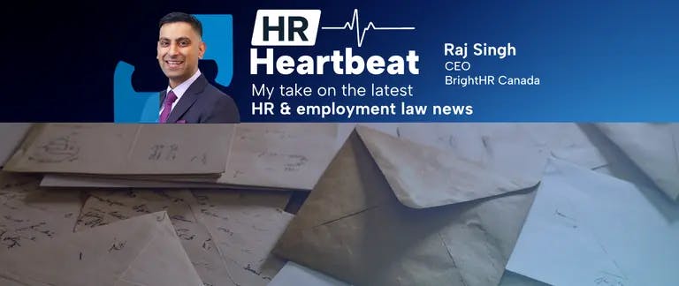 A man in a suit is standing in front of a pile of envelopes.