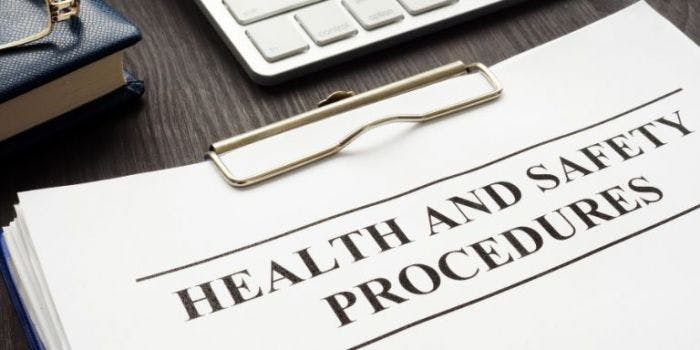 An image of a clipboard with the words "health and saftey procedures" on the front of the document