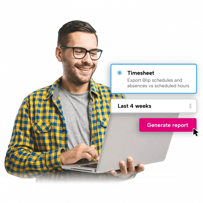 A man wearing glasses is smiling while using a laptop computer.