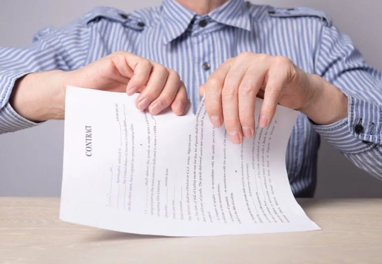 man tearing paper