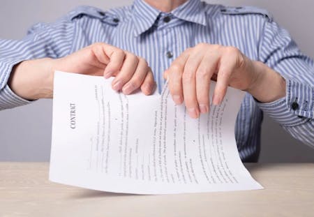 man tearing paper