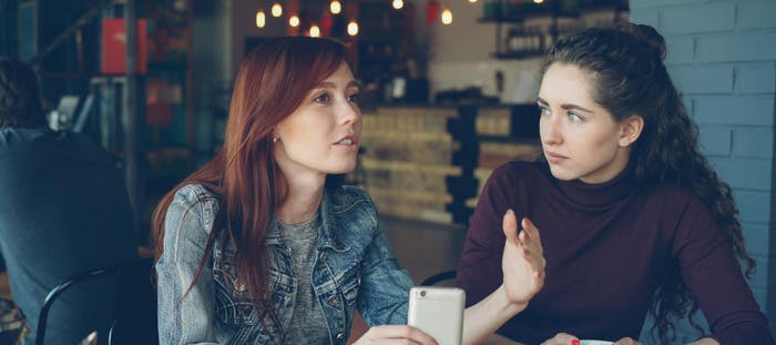 Two employees having a conversation about a difficult topic at work.