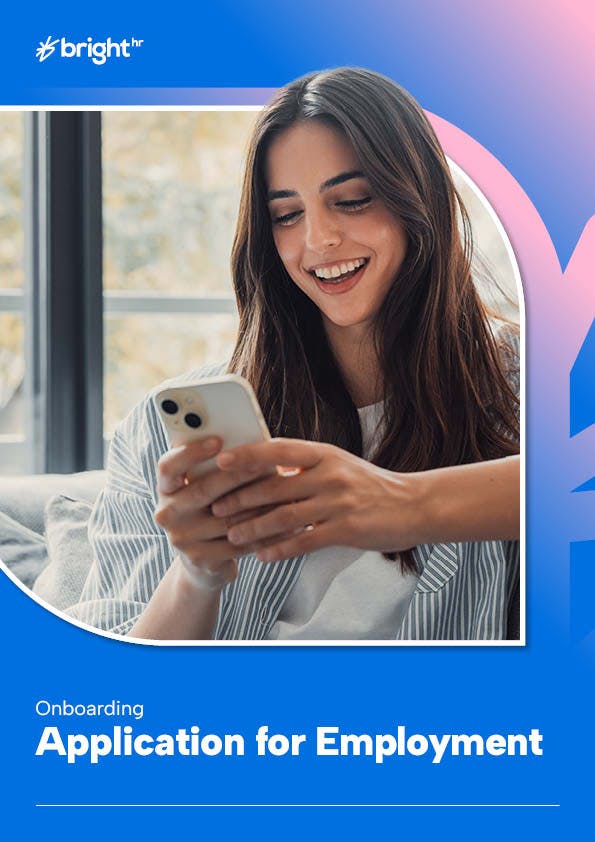 A woman with long brown hair is smiling while using her phone. She is wearing a white shirt and has her eyes closed. The background is blue with a window visible through it.