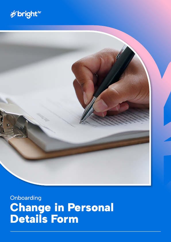 The image features a hand holding a black pen, writing on a white paper.
