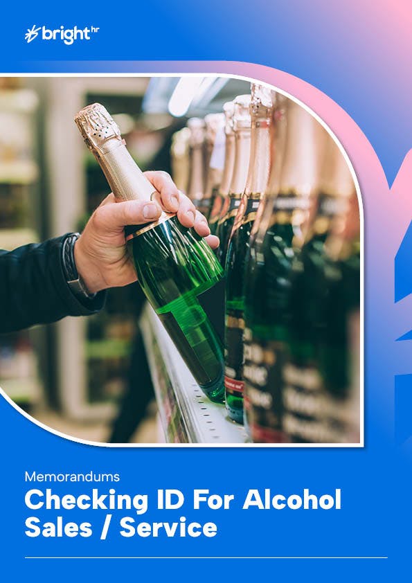 A hand is holding a champagne bottle, which is being lifted from a shelf filled with champagne bottles.