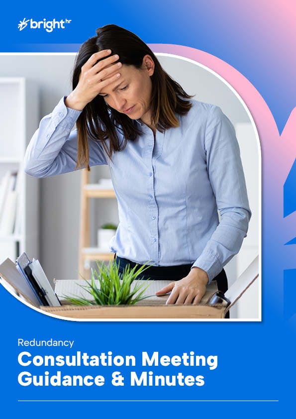 Woman in office at desk packing her belongings