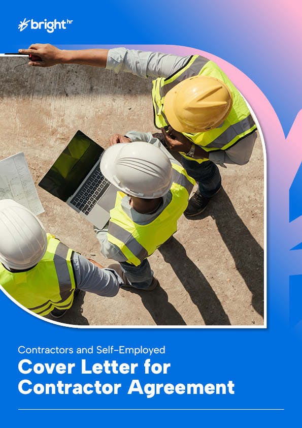 Three construction workers wearing hard hats and safety vests are working on a construction site. One worker is pointing at a laptop computer