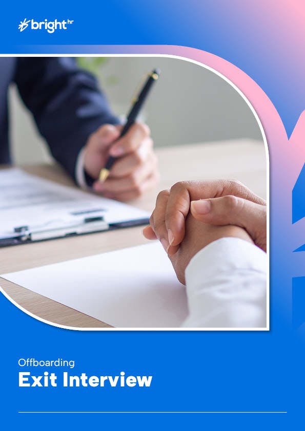 A hand is holding a pen over a piece of paper, with the person's hand visible in the background.