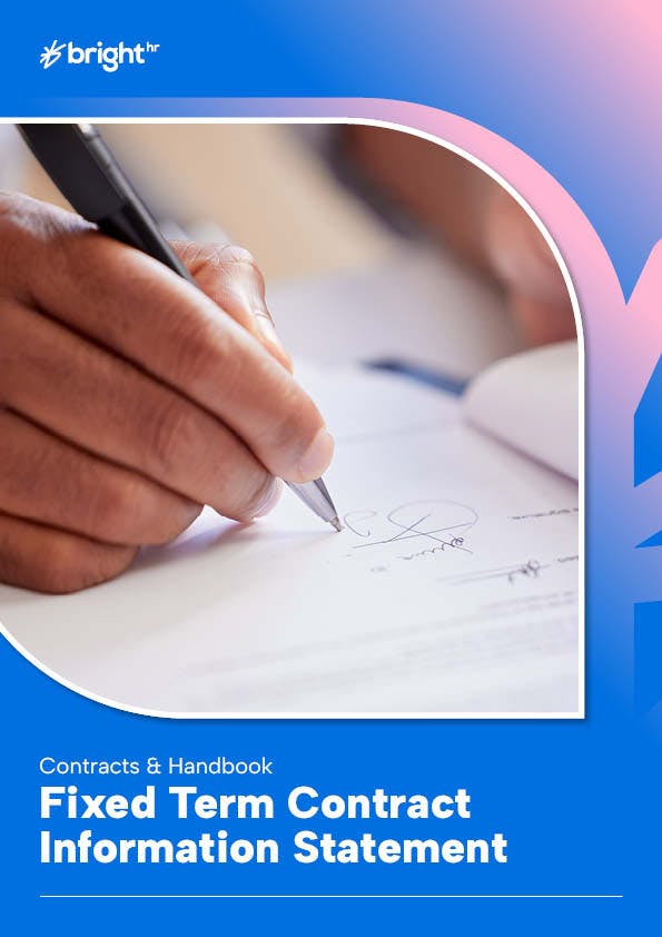 A hand is writing on a piece of paper with a pen, which is positioned in the center of the image.