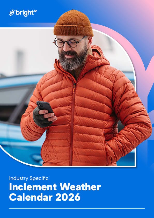 Picture of man in orange jacket and beanie using phone