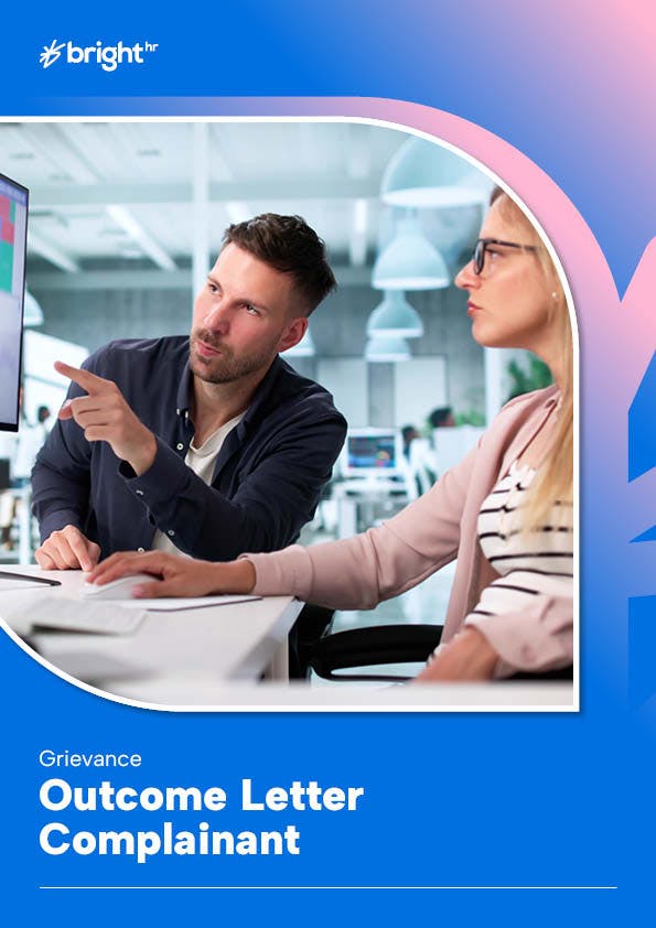 two staff members in a discussion referring back to information on computer