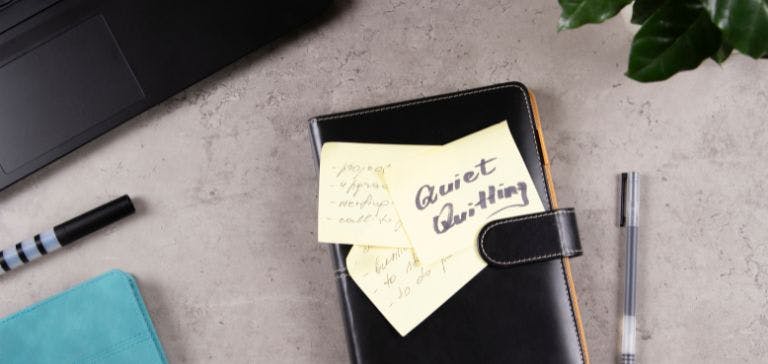 quiet quitting picture of notebook and pen on desk