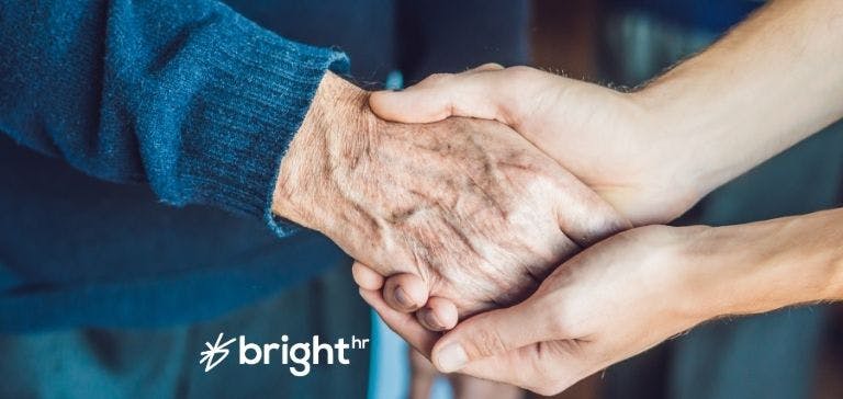 Aged care worker holding hand of elderly person