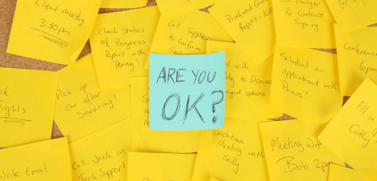 pinboard covered in post-it notes, centre states are you ok?