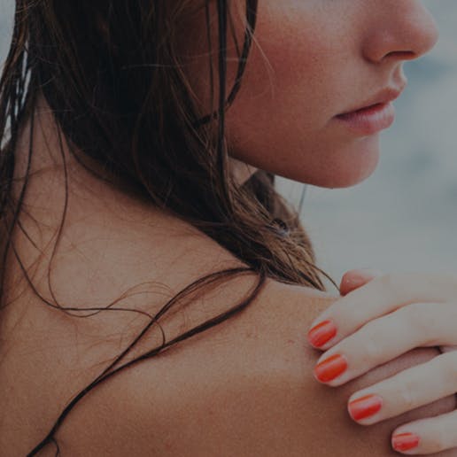 Closeup of woman's hand on her shoulder.