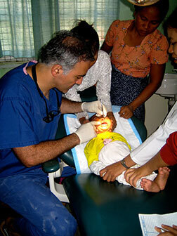 Dr. Alizadeh examining a young child.