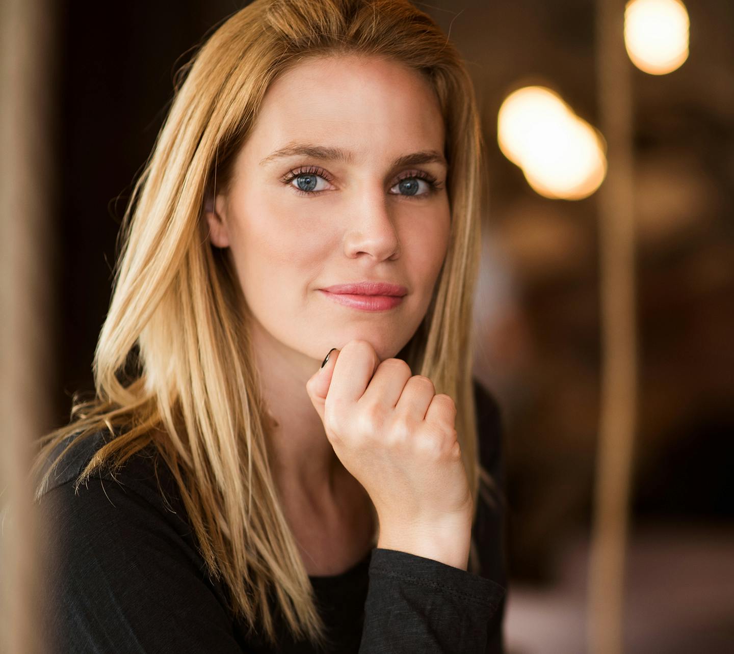 Woman posing with chin on fist.