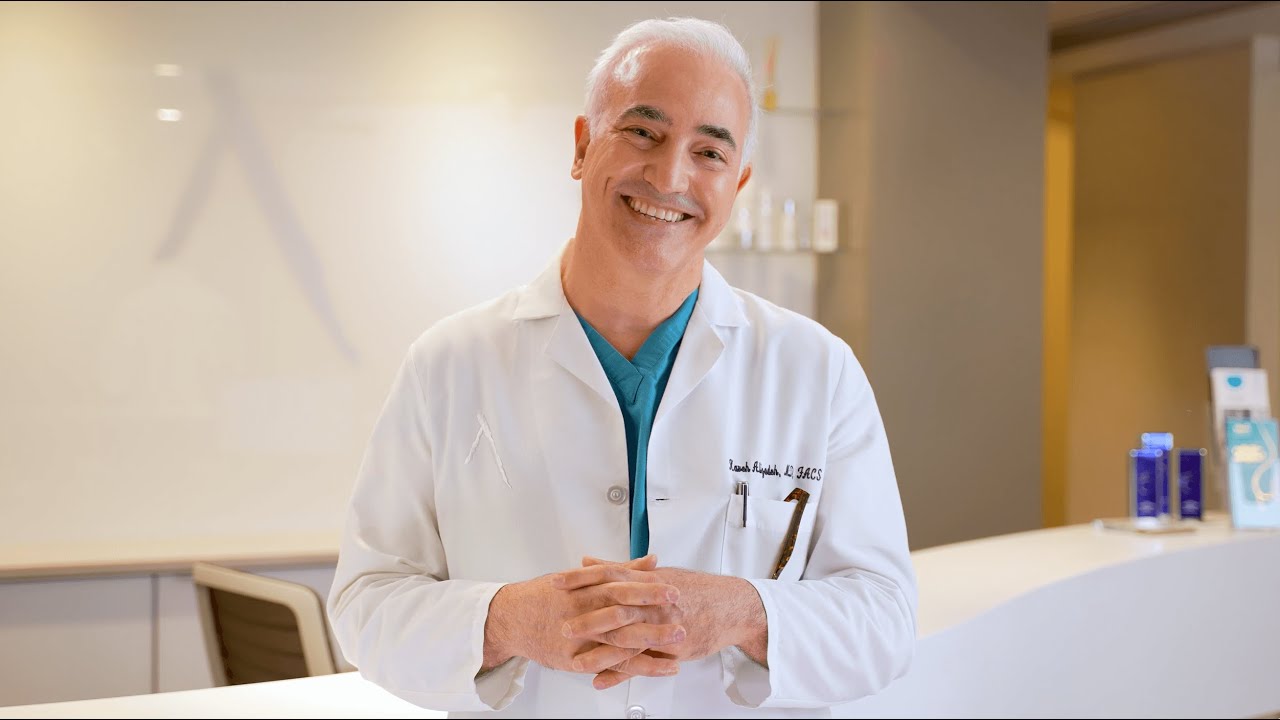 Dr. Alizadeh, board-certified plastic surgeon in NYC, smiling at the camera