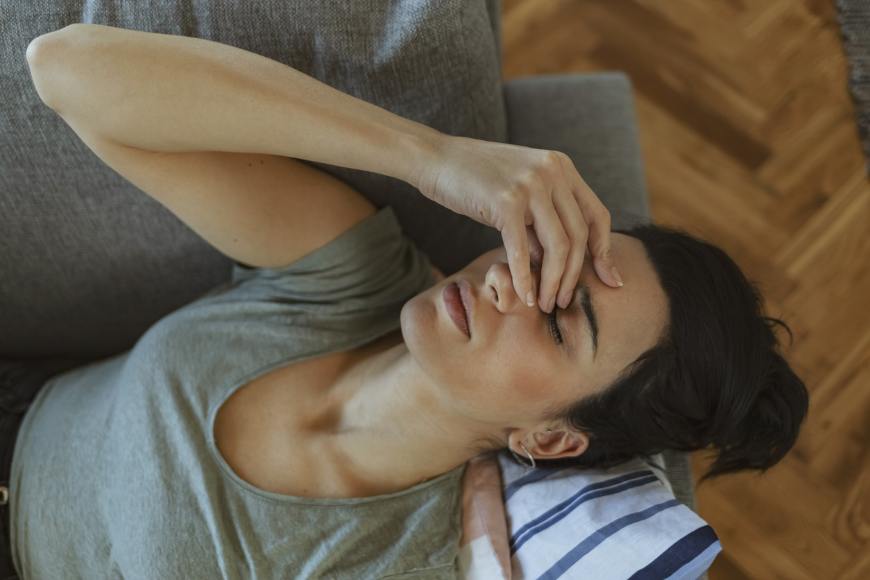 Woman on a couch in pain.