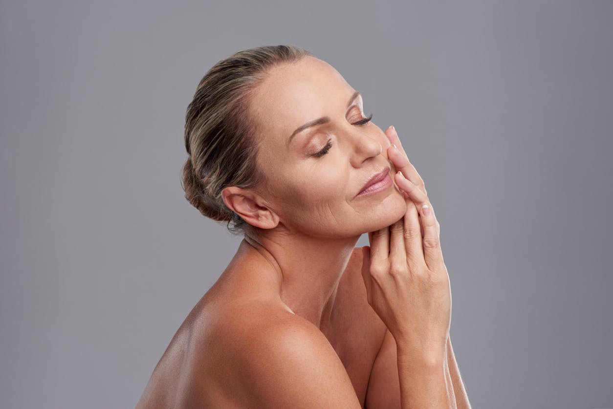 Blonde model touching the side of her face