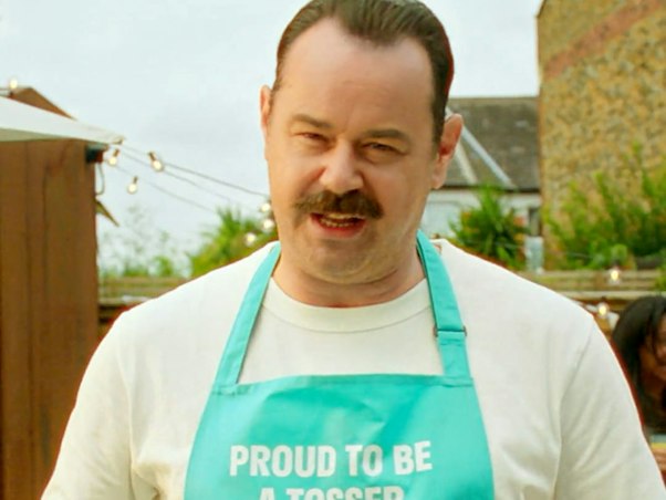 Danny Dyer in a Proud To Be A Tosser apron tossing a salad for Deliveroo