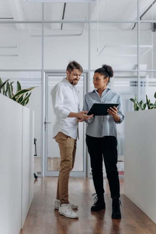 Two colleagues looking at a tablet