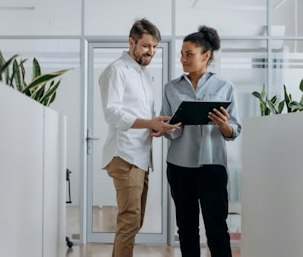 Two colleagues looking at a tablet
