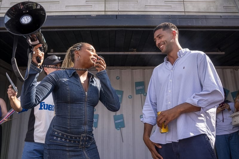Two people laughing with a megaphone