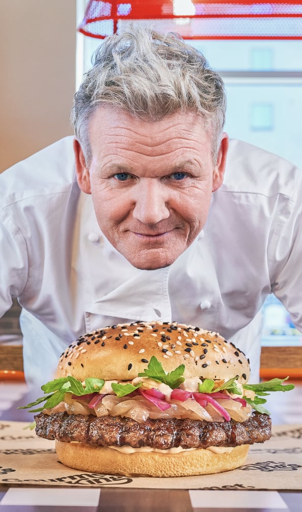 Gordon Ramsay holding up a burger
