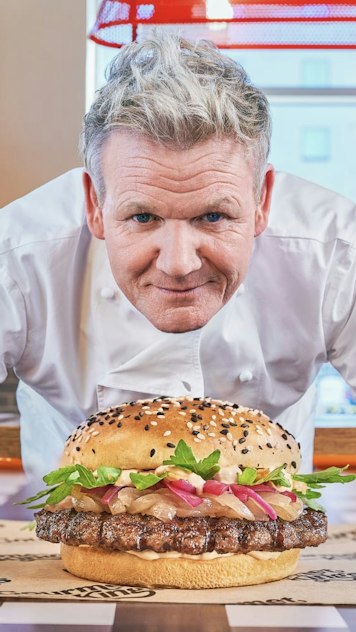 Gordon Ramsay holding up a burger